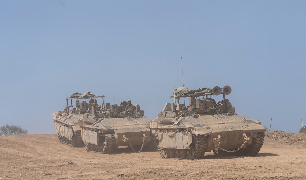 Israeli forces drive personnel carriers (APC) near the border with Gaza Strip on April 15, 2024. (AP)
