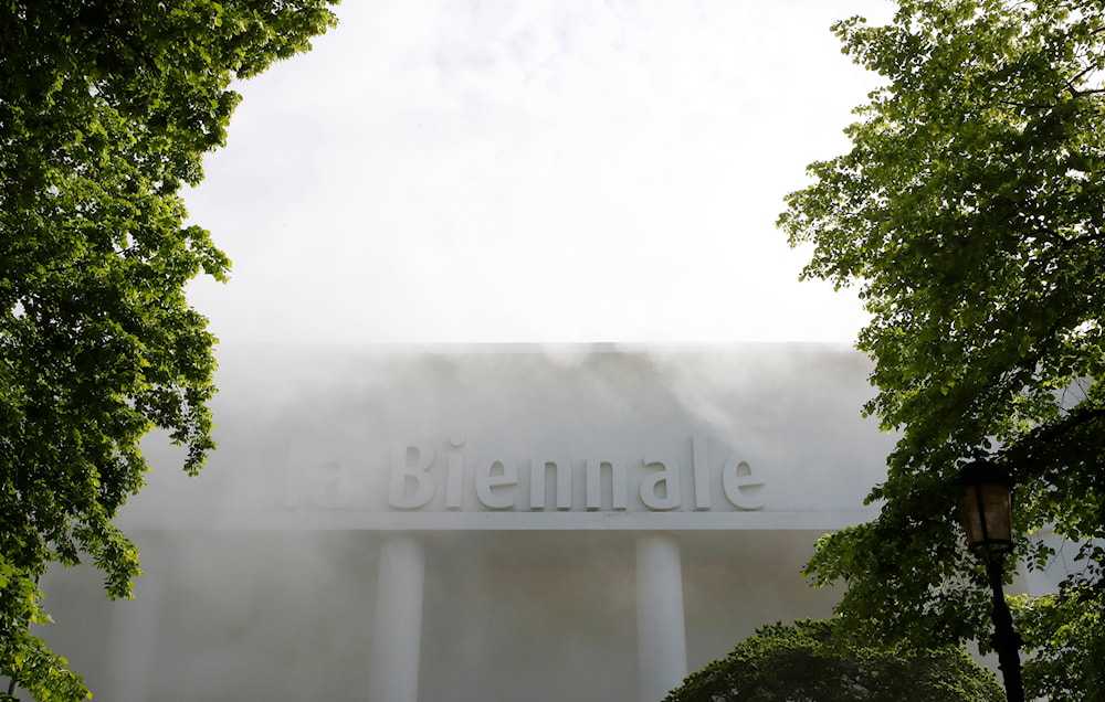 A building with writing Biennale is surrounded by a smoke effect in view of the 58th Biennale of Arts exhibition in Venice, Italy, on May 7, 2019. (AP)