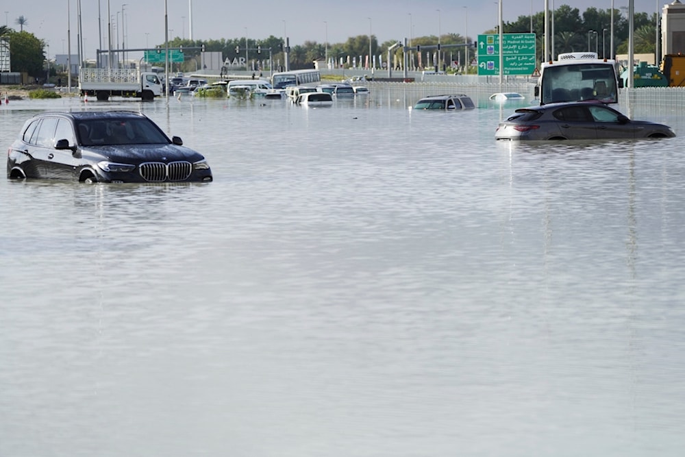 Vehicles sit abandoned in floodwater covering a major road in Dubai, United Arab Emirates, Wednesday, April 17, 2024 (AP)