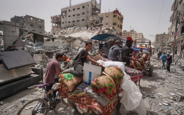 Palestinians child packing his family’s belongings in a truck as they were forcibly displaced from al-Nuseirat in the central Gaza Strip on April 18, 2024 amid the ongoing Israeli genocide. (AFP)