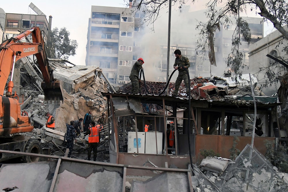 emergency service workers clear the rubble at a destroyed building struck by Israeli jets in Damascus, Syria, Monday, April 1, 2024. (SANA/AP)