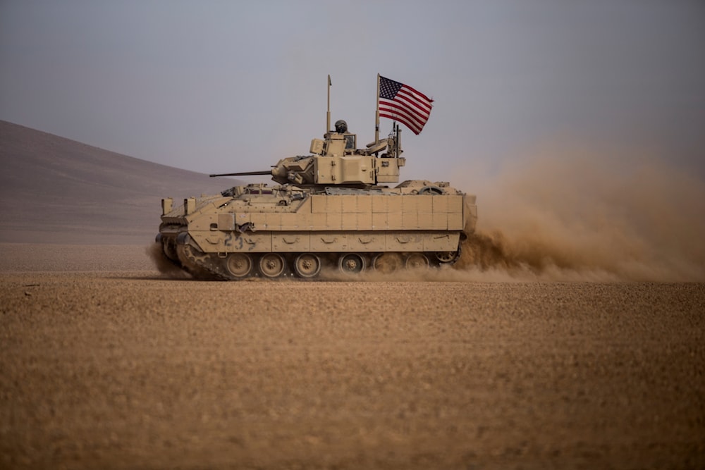 American soldiers drive a Bradley fighting vehicle during a joint exercise with Syrian Democratic Forces at the countryside of Deir Ezzor in northeastern Syria, Dec. 8, 2021. (AP)
