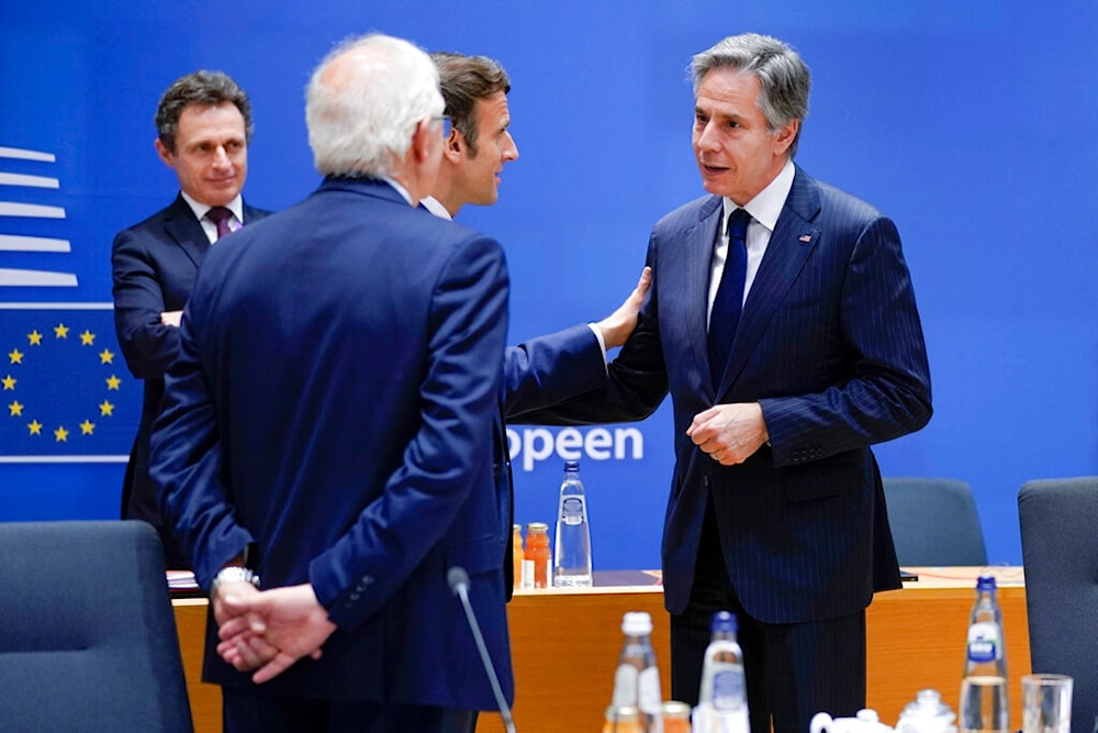 Secretary of State Antony Blinken, right, talks with French President Emmanuel Macron during a round table meeting at an EU summit in Brussels, Thursday, March 24, 2022. (AP)