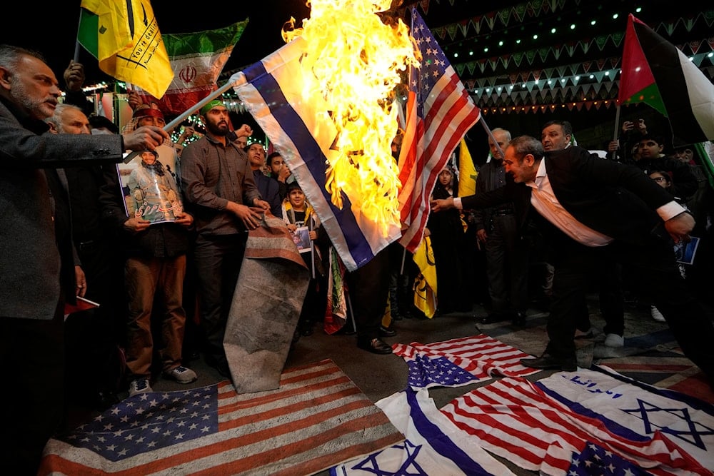 Iranian protesters burn representations of the US and Israeli flags during their gathering to condemn killing members of the Iranian Revolution Guard Corps in Syria, at the Felestin (Palestine) Sq. in downtown Tehran, Iran, April 1, 2024 (AP)