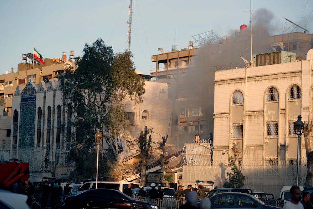 Emergency services work at a destroyed building hit by an air strike in Damascus, Syria, April 1, 2024 (AP)