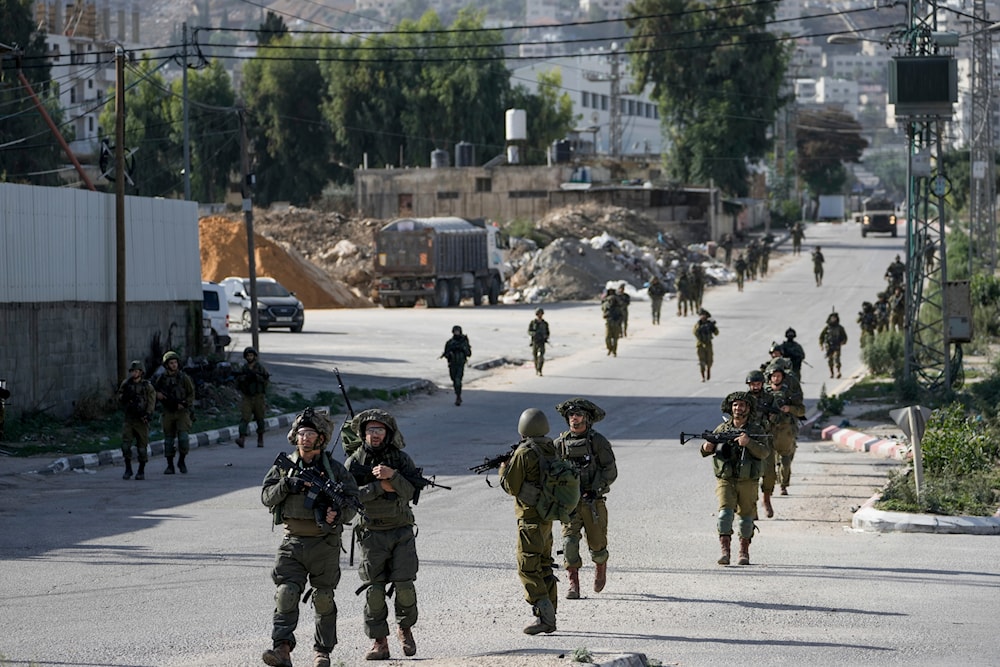 Israeli soldiers are seen in Balata, a Palestinian refugee camp in Nablus, West Bank, November 23, 2023 (AP)