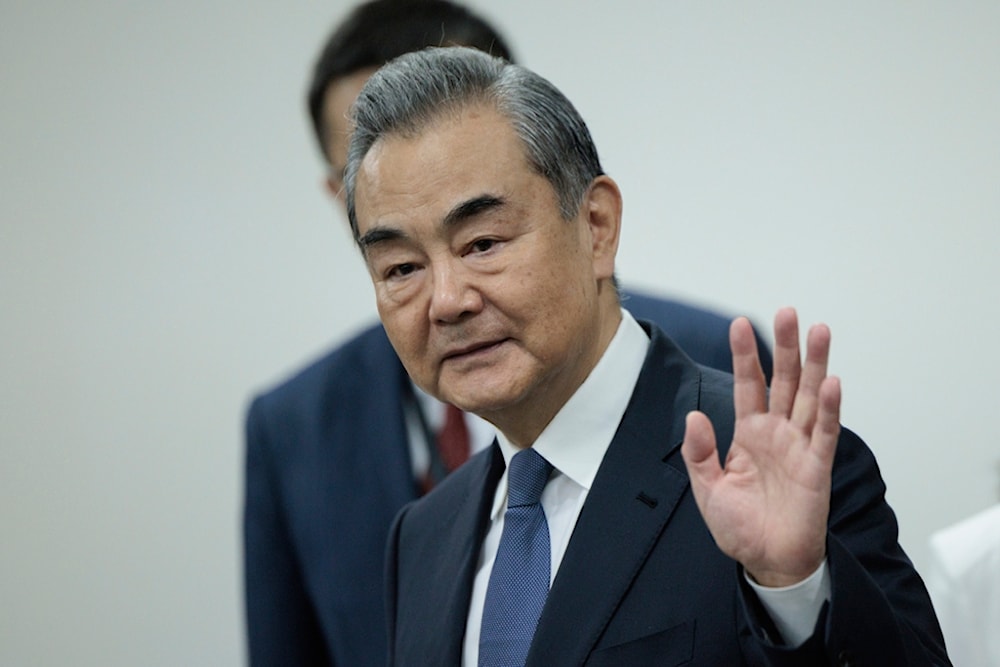 Chinese Foreign Minister Wang Yi waves before the start of his bilateral meeting with Indonesian Foreign Minister Retno Marsudi in Jakarta, Indonesia, Thursday, April 18, 2024. (AP)