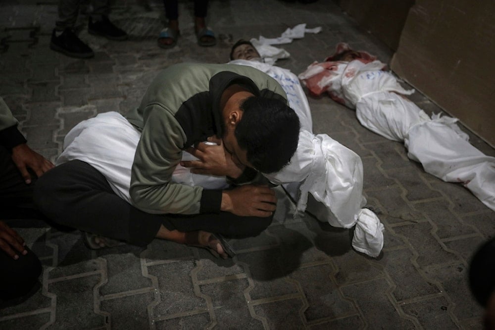 A Palestinian youth mourns his relative killed in the Israeli bombardment of the Gaza Strip, at the morgue of the Kuwaiti Hospital in Rafah refugee camp, southern Gaza Strip, April 20, 2024. (AP)