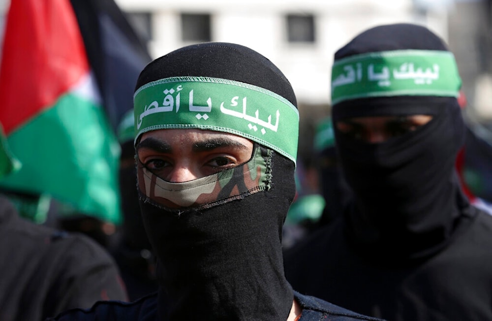 Masked Hamas militants wave their national flags during a protest against the Mideast plan announced by U.S. President Donald Trump, in Gaza City, Feb. 21, 2020. (AP)