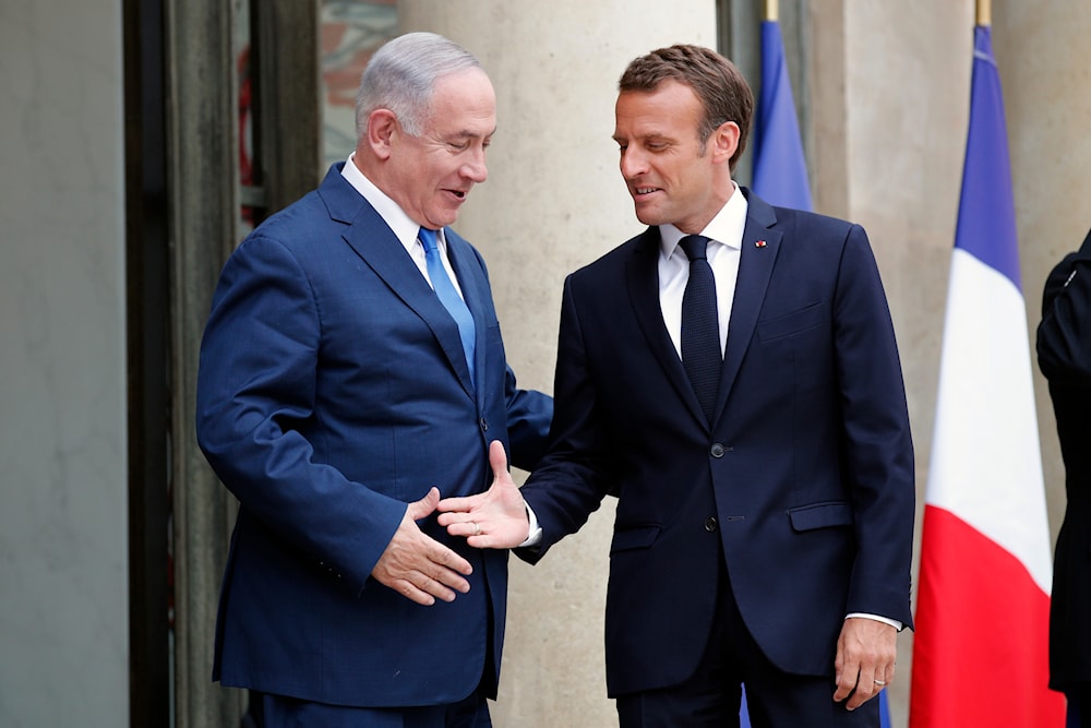 French President Emmanuel Macron, right, welcomes Israel's Prime Minister Benjamin Netanyahu prior to their meeting at the Elysee Palace, in Paris, Tuesday, June 5, 2018. (AP)