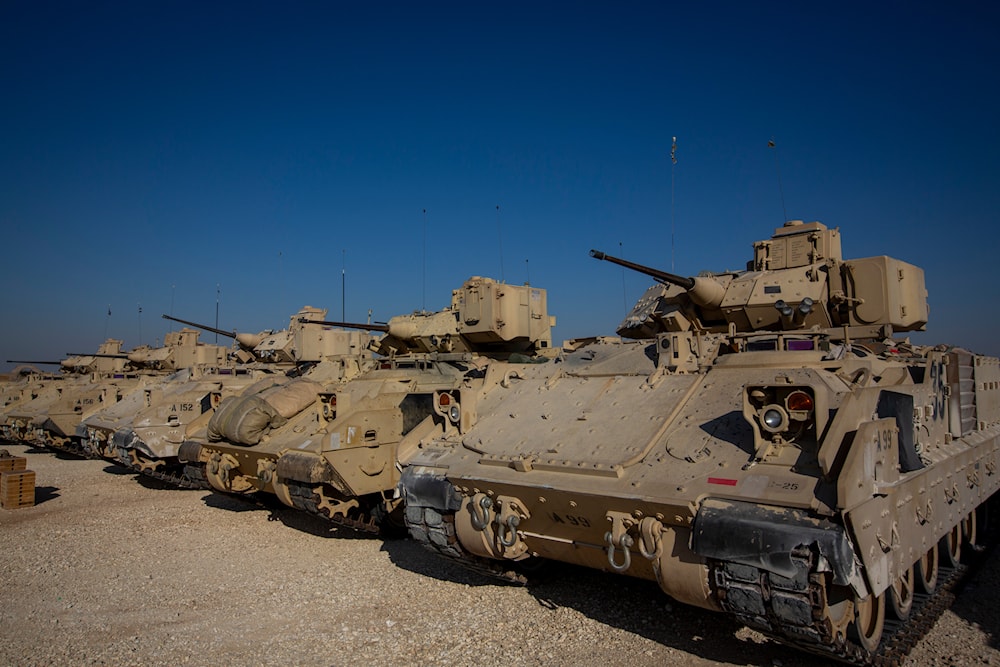 Bradley fighting vehicles are parked at a US occupation military base at an undisclosed location in Northeastern Syria, November 11, 2019 (AP)