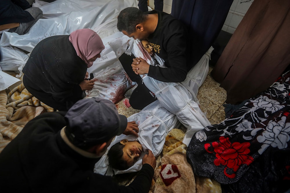 Palestinians mourn over their relatives killed by the Israeli bombing of the Gaza Strip at the morgue of Al-Aqsa Hospital in Deir al-Balah, Gaza Strip, Wednesday, April 10, 2024. (AP)
