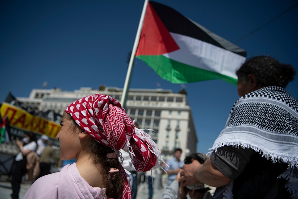 A girl holds a Palestinian flag during a protest rally at Syntagma Square, central Athens, Greece, Saturday, March 30, 2024. Palestinians living in Greece rallied in front of the Parliament to protest 'Israel's' war against Gaza.(AP)