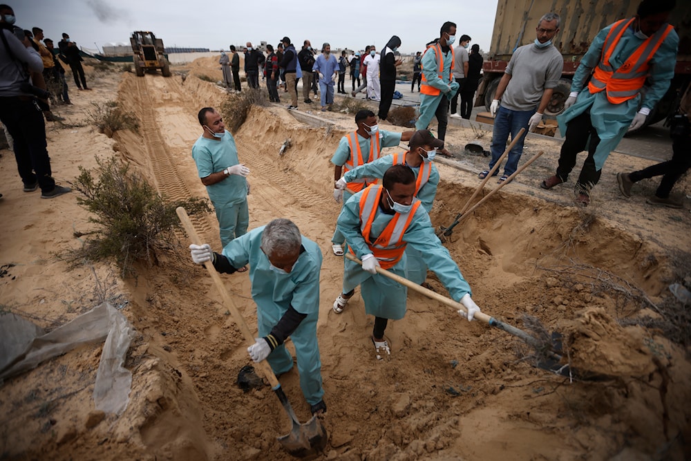 Palestinians dig a mass grave to bury Palestinians killed in the Israeli bombing, who were brought from the Shifa hospital to the town of Khan Younis, southern Gaza Strip, Wednesday, Nov. 22, 2023. (AP)