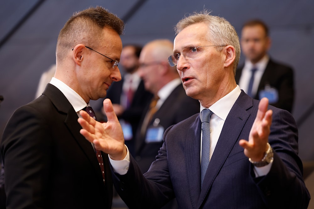 NATO Secretary General Jens Stoltenberg with Hungary's Foreign Minister Peter Szijjarto during a meeting at NATO headquarters in Brussels, Wednesday, April 3, 2024. (AP)