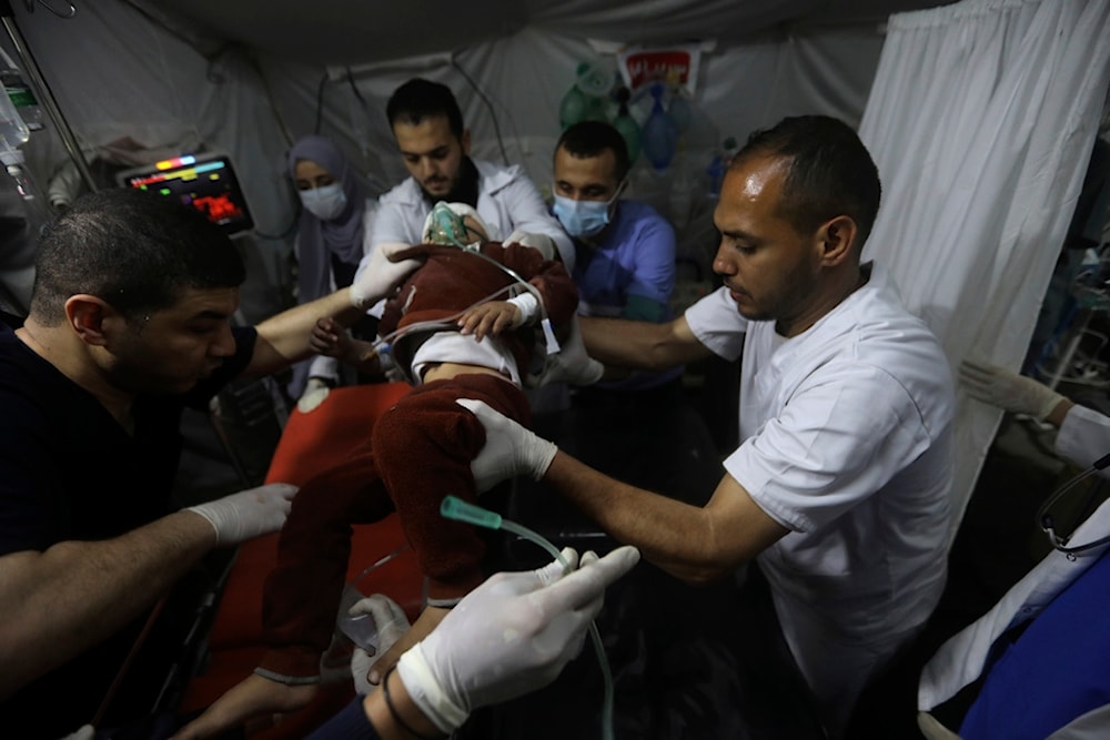 Palestinian medics carry a young wounded in the Israeli bombardment of the Gaza Strip, to the Kuwaiti Hospital in Rafah refugee camp, southern Gaza Strip, April 20, 2024 (AP Photo/Ismael Abu Dayyah)