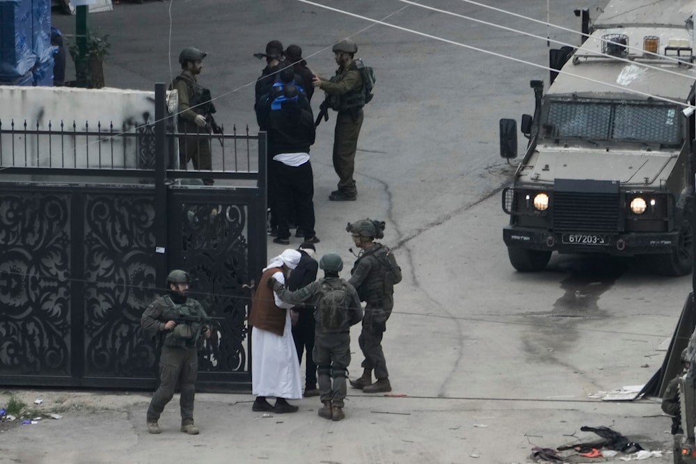 Israeli occupation detaining Palestinian men during a raid in Nur Shams refugee camp in Tulkarm, West Bank on Wednesday, Jan. 3, 2024.(AP)