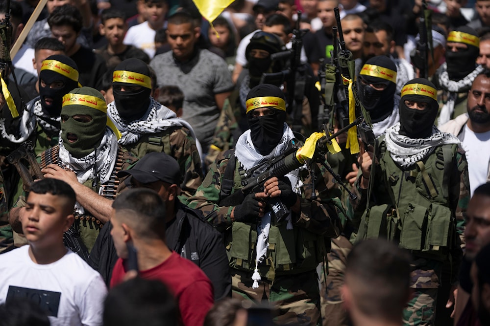 Al-Aqsa Martyrs Brigades freedom fighters, the military wing of Fatah Movement, attend the funeral of Palestinians Jihad Sami and Odai Shami in the West Bank city of Nablus, Saturday, May 6, 2023. (AP)