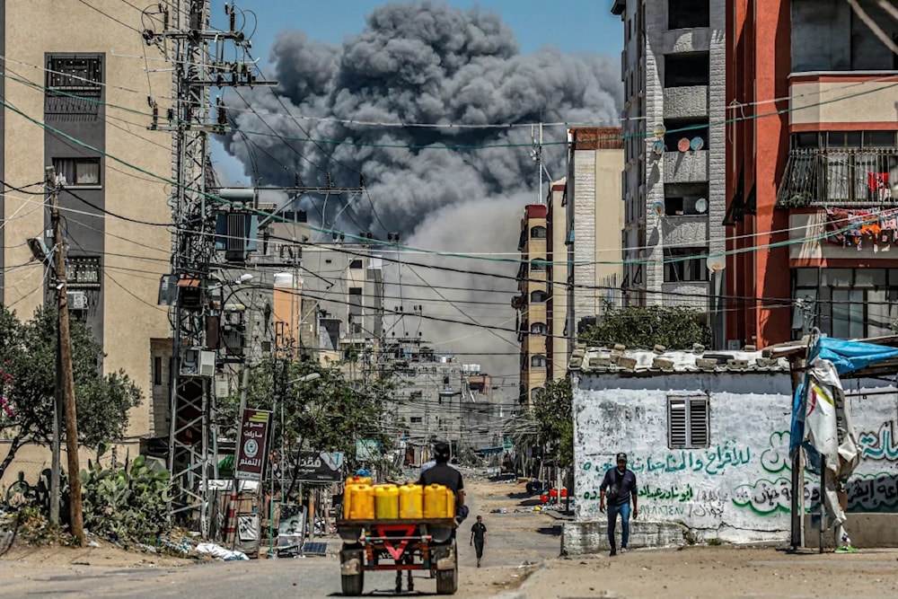 A cloud of smoke erupts following an Israeli attack on residential area in central Gaza Strip on April 17, 2024 (AFP)