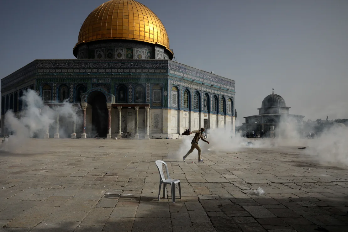 Illustrative: A Palestinian worshipper runs from tear gas fired by IOF at Al Aqsa Mosque in 2021. (AP)