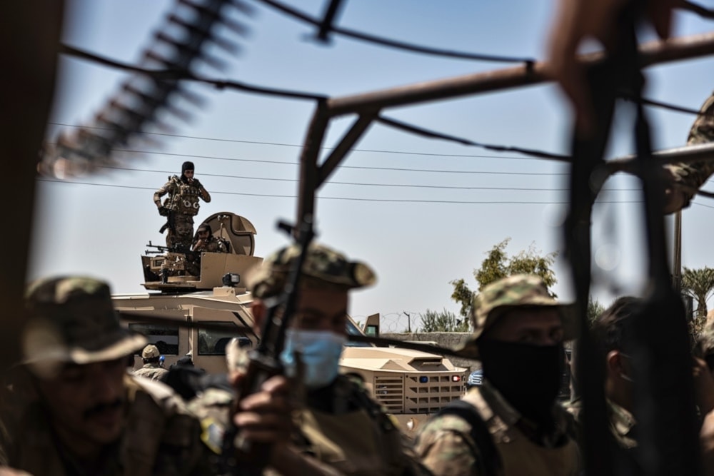 US-backed Syrian democratic forces SDF militants sit on their armored vehicles, at al-Sabha town in the eastern countryside of Deir Ezzor, Syria, Monday, September 4, 2023. (AP)