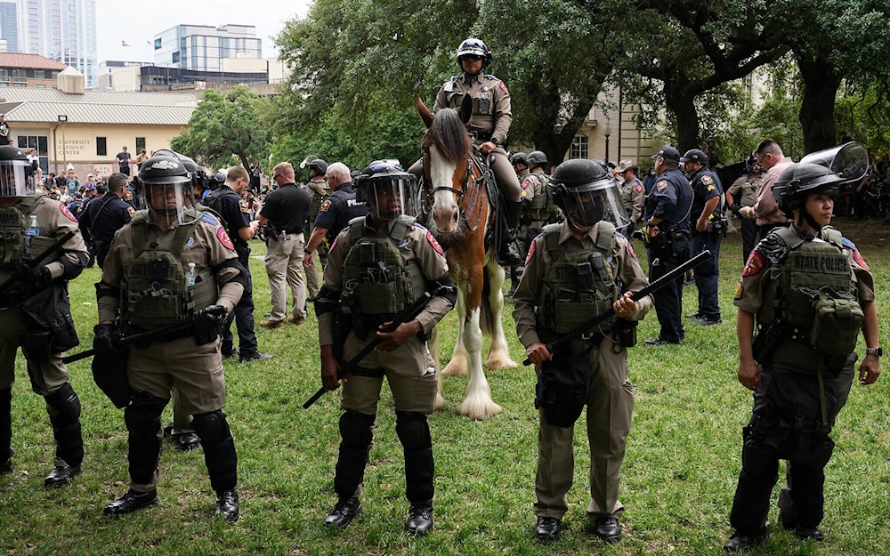 Texas State Troopers and other law enforcement personnel monitor the scene as pro-Palestinian students protest against Israeli genocide, on the campus of the University of Texas in Austin on April 24, 2024. (AFP)