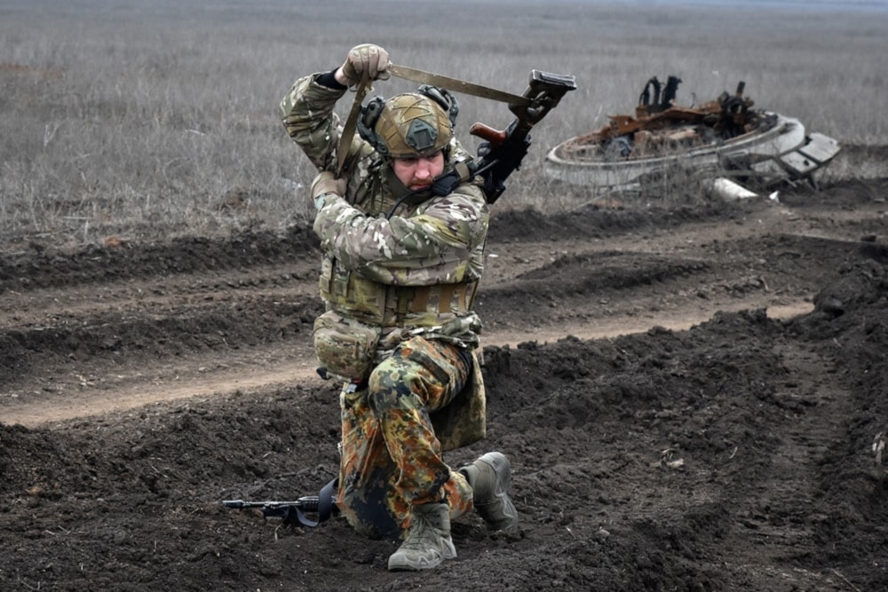 Illustrative: A Ukrainian soldier picks up a machine gun after a heavy fight on the front line in the village of Robotyne, Ukraine, Friday March 1, 2024. (AP)