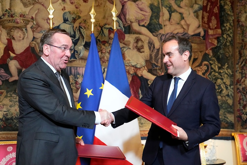 French Defense Minister Sebastien Lecornu , right, and his German counterpart Boris Pistorius shakes hands after signing an agreement in Paris Friday, April 26, 2024. (AP)