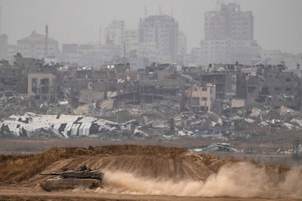 Israeli soldiers move on the top of a tank near the separation line, as seen from southern Palestine, Thursday, April 25, 2024. (AP Photo/Leo Correa)