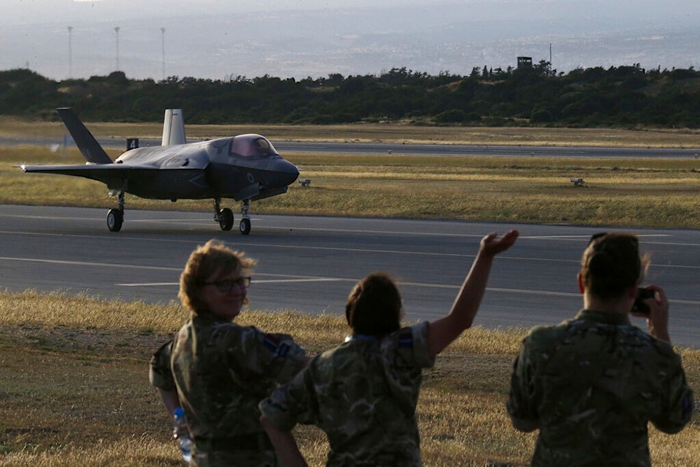 Soldiers wave at a F-35B aircraft waves after landing at Akrotiri Royal air forces base near coastal city of Limassol, Cyprus, Tuesday, May 21, 2019, the jets first training deployment outside of the UK. (AP)
