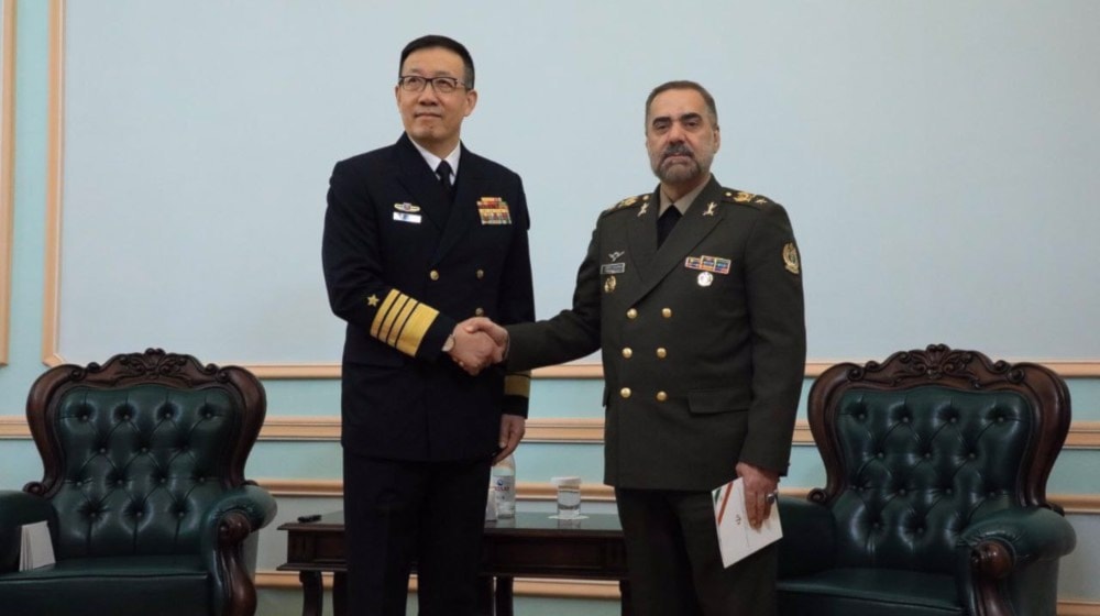 Iran's Defense Minister Brigadier General Mohammad Reza Ashtiani shakes hands with his Chinese counterpart Dong Jun during a meeting in Astana, Kazakhstan, on April 26, 2024.  (Iran's Defense Ministry)