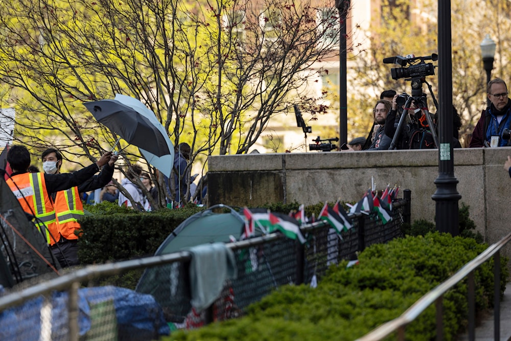 People block views from members of the media at pro-Palestine demonstration encampment at Columbia University, April 26, 2024, in New York (AP)