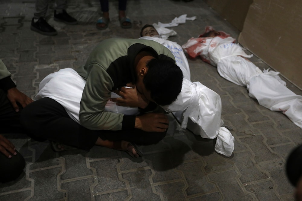 A Palestinian youth mourns his relative killed in the Israeli bombing of the Gaza Strip, at the morgue of the Kuwaiti Hospital in Rafah refugee camp, southern Gaza Strip, early Saturday, April 20, 2024. (AP)