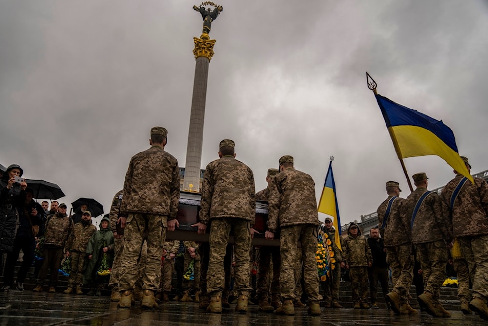 Honour guards carry the coffin of Ukrainian army paramedic Nazarii Lavrovskyi, 31, killed in the war, during his funeral ceremony at Independence square in Kyiv, Wednesday, April 24, 2024. (AP)