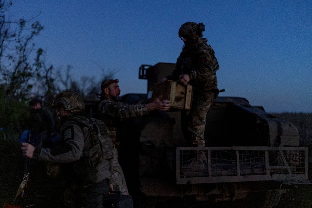 Ukrainian servicemen from Code 9.2 unit unloaded ammunition from Humvee at the frontline positions, few kilometres from Bakhmut, Donetsk region, Ukraine, Tuesday, April 23, 2024. (AP)