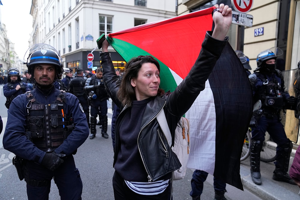A woman holds a Palestine flag near Sciences-Po university in Paris on Friday, April 26, 2024.(AP)