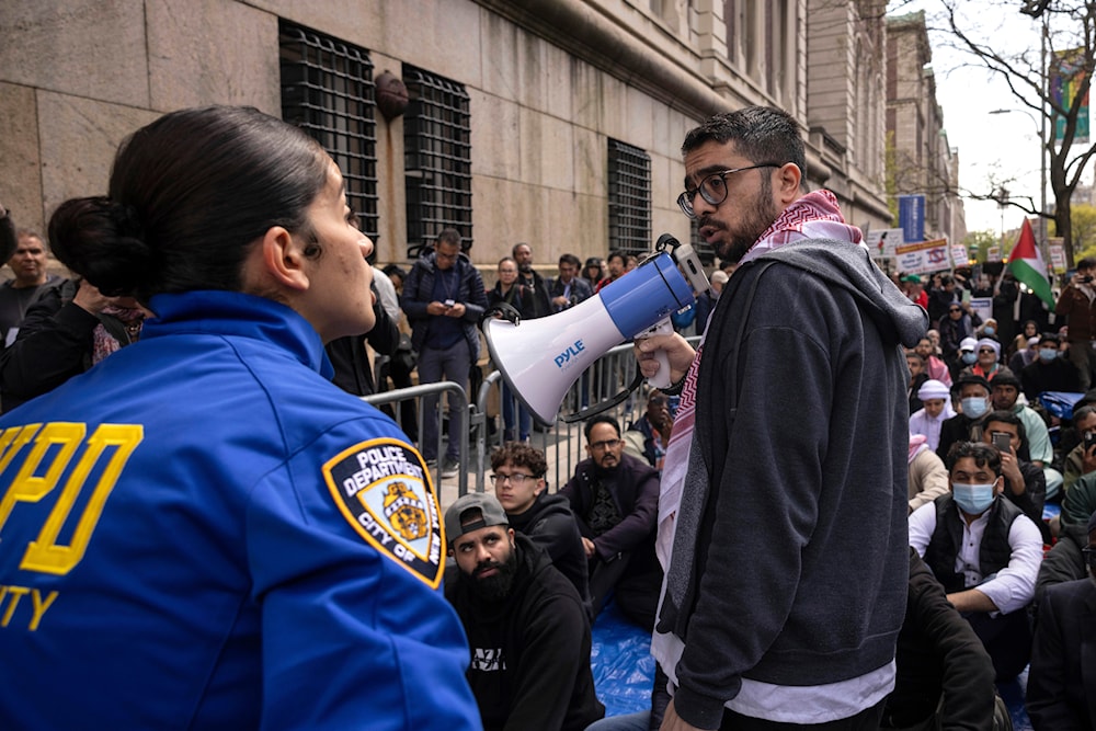 NYPD officer tells a person not to use the megaphone during the 