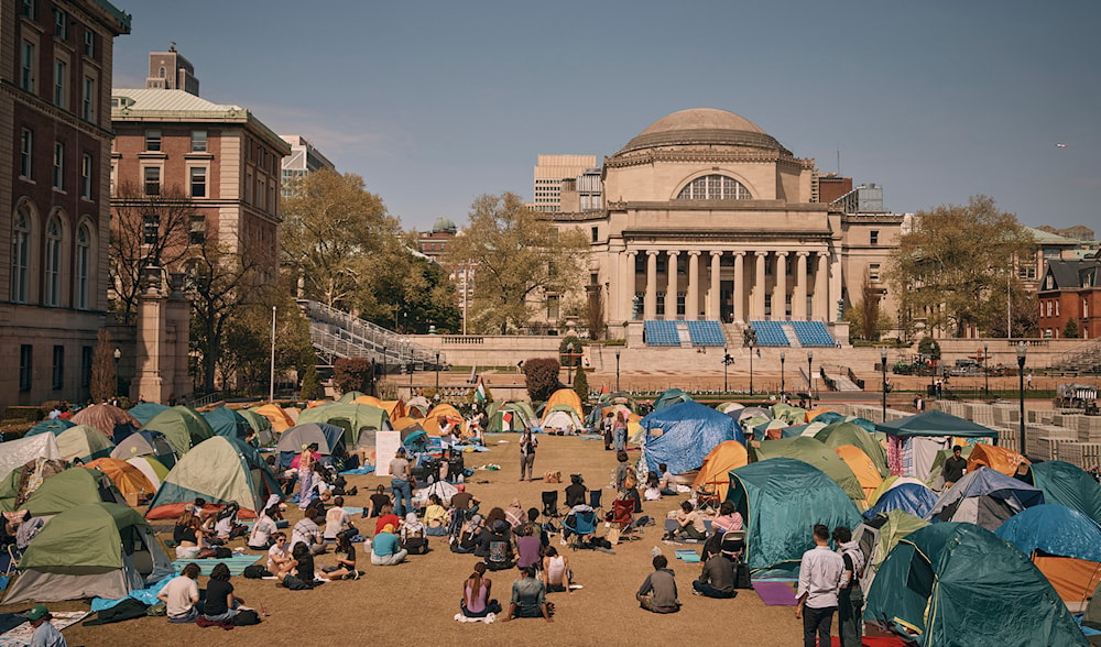 People listen to a speaker at a pro-Palestinian encampment inside the campus of Columbia University, Sunday, April 28, 2024, in New York. (AP)