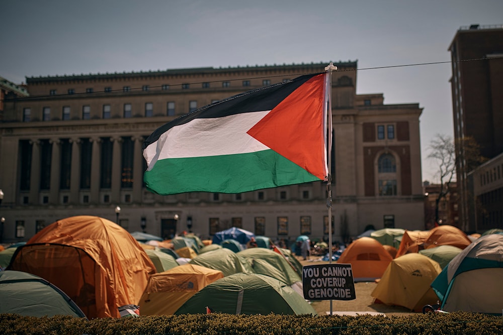 People listen to a speaker at a pro-Palestinian encampment, inside the campus of Columbia University, April 28, 2024, in New York (AP)