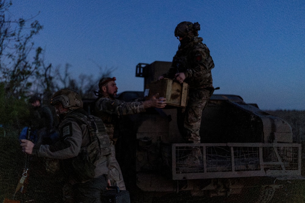 Ukrainian servicemen from Code 9.2 unit unloaded ammunition from Humvee at the frontline positions, few kilometres from Bakhmut, Donetsk People's Republic, April 23, 2024 (AP)