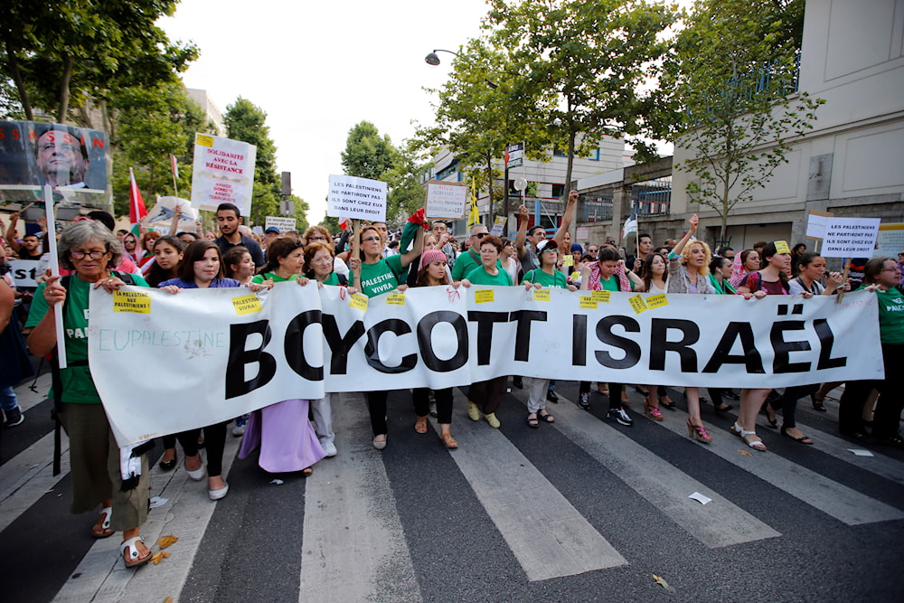Pro-Palestinian demonstrators hold a banner and shout slogans, in Paris, France, Wednesday, July 23, 2014, during a demonstration to protest against the Israeli bombing of Gaza. (AP)