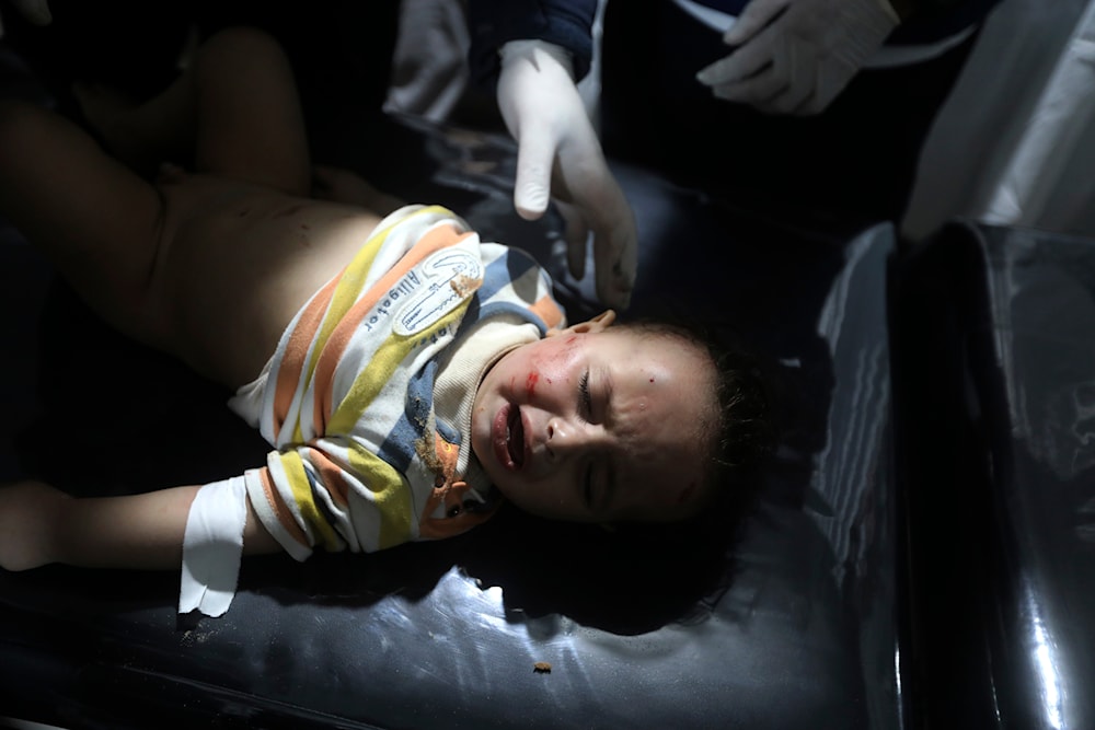 Palestinian medics treat a wounded child in the Israeli bombardment of the Gaza Strip at the Kuwaiti Hospital in Rafah refugee camp on April 19, 2024. (AP)