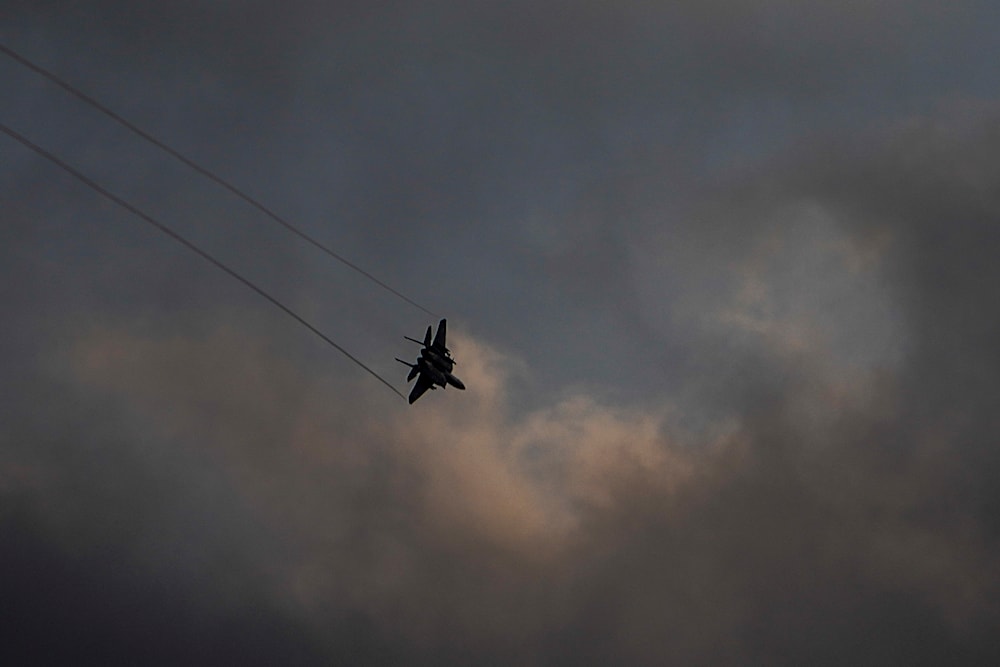 An Israeli Air Force F-15 jet fighter maneuvers over northern occupied Palestine on the border area with Lebanon, February 27, 2024 (AP)