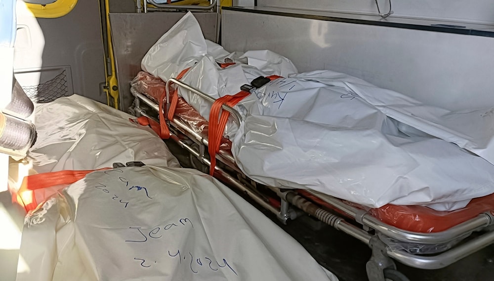 Bodies of the foreign aid workers killed in a recent Israeli airstrike in Gaza, are seen on an ambulance as it crosses the Rafah border crossing between Egypt and the Gaza Strip, April 3, 2024. (AP)