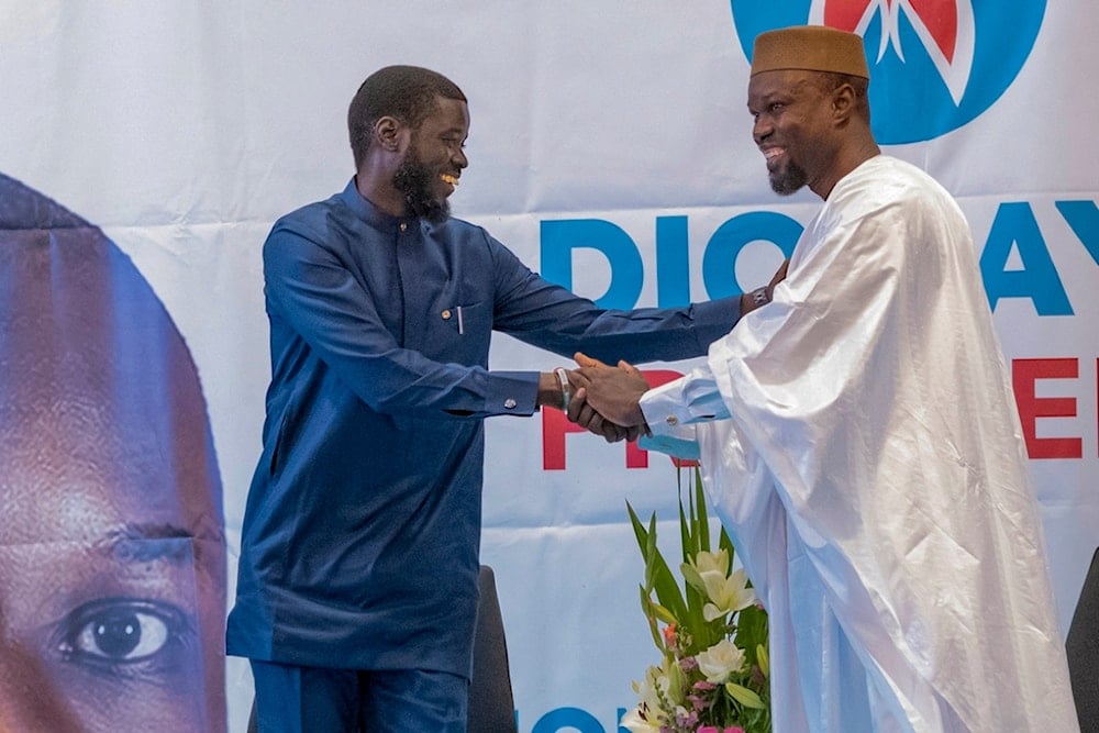 Senegal's top opposition leader Ousmane Sonko, right, and his key ally Bassirou Diomaye Faye address supporters in Dakar, Senegal, Friday March 15, 2024 (AP)