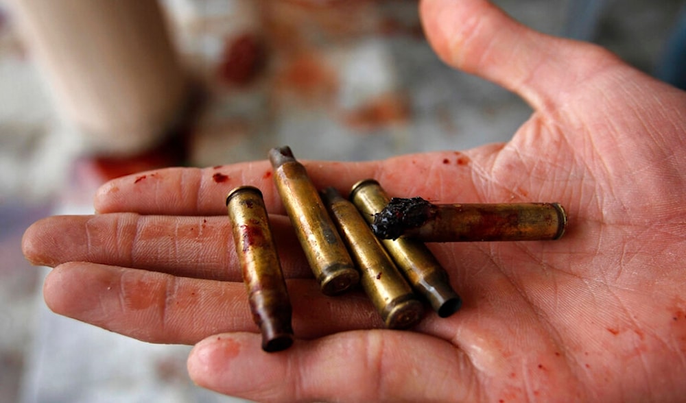 An Afghan man displays some of the used bullets at the scene where Sabar Lal Melma, who was killed in a NATO and Afghan forces raid in Jalalabad, Kabul, Afghanistan, Sept. 3, 2011. (AP)