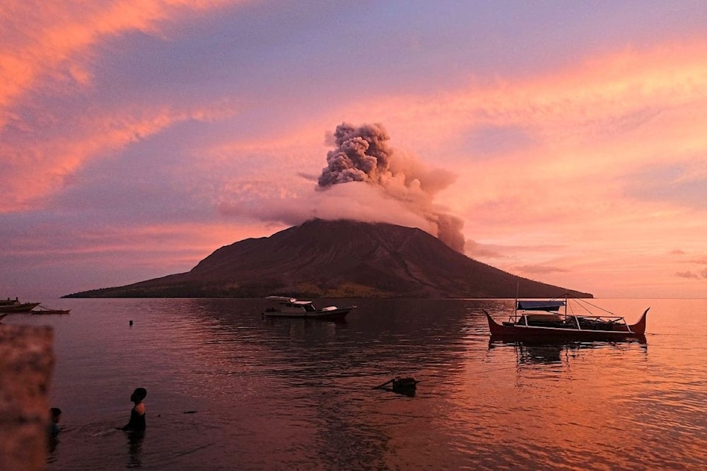 Mt Ruang erupting in Sitaro, North Sulawesi, sending a tower of ash spewing into the sky (AFP)