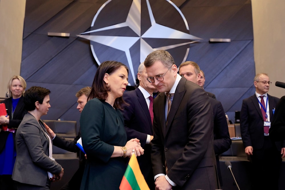 Germany's Foreign Minister Annalena Baerbock, left, speaks with Ukraine's Foreign Minister Dmytro Kuleba during a meeting of the NATO-Ukraine Council at NATO headquarters in Brussels, April 4, 2024. 