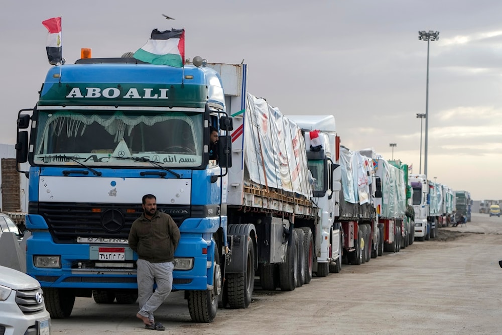 Trucks carrying humanitarian aid line up at the Rafah Border Crossing, Egypt, on the way to Gaza, Sunday, Nov. 19, 2023 (AP)