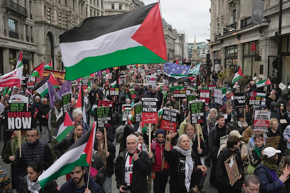 Pro-Palestinian protesters hold up banners, flags, and placards during a demonstration in London, on Saturday, Feb. 3, 2024, as they demand a full cease-fire and an end to the siege of Gaza. (AP)